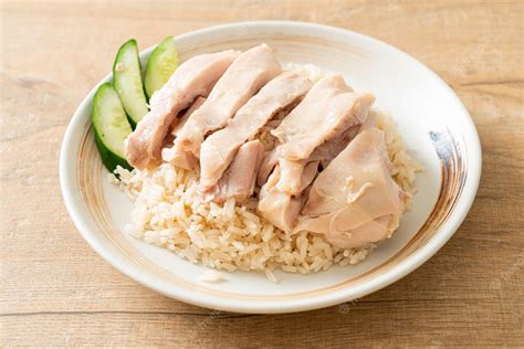 Premium Photo | Hainanese chicken rice or rice steamed with chicken soup