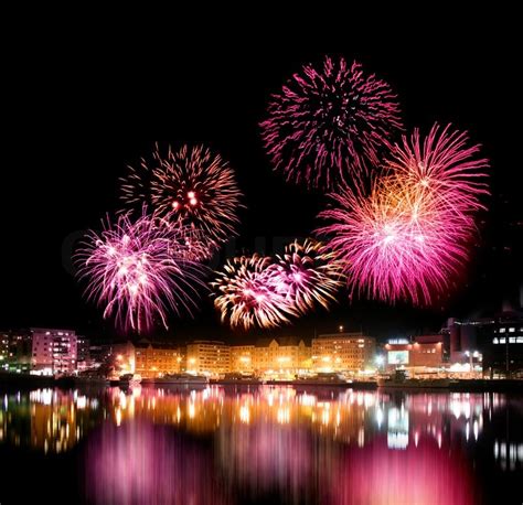 Fireworks night over city with calm water reflection | Stock Photo ...