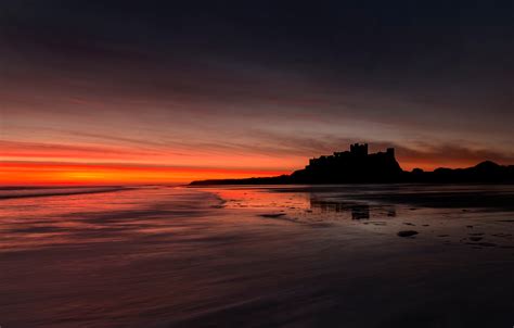 Download Orange (Color) Horizon Sunset Beach Silhouette Castle England Man Made Bamburgh Castle ...