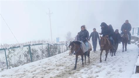 Tourists in for a surprise as snowfall, rains bring early winter in ...