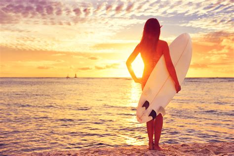 Surfer girl surfing looking at ocean beach sunset – Waterton Publishing Company