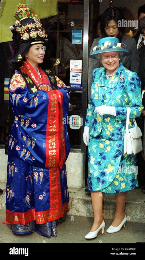 The Queen passes a woman in traditional mediaeval costume as she leaves ...