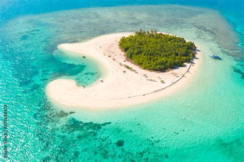 Patawan island. Small tropical island with white sandy beach. Beautiful island on the atoll ...