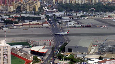 The runway at the Gibraltar International Airport has a road crossing ...