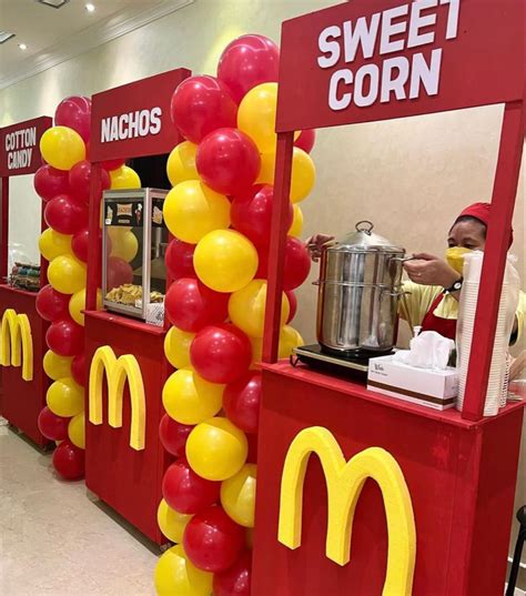 a mcdonald's sweet corn stand is decorated with red, yellow and white ...