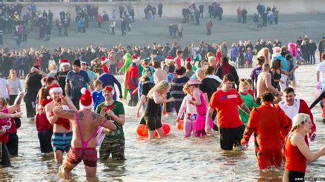 Hundreds brave boxing day dips in North East - BBC News