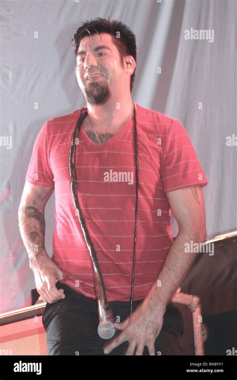 Deftones vocalist Chino Moreno is shown singing on stage during a "live" concert performance ...