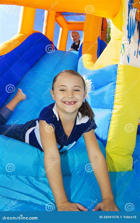 Kids Playing On An Inflatable Slide Bounce House Royalty Free Stock Image - Image: 26941576