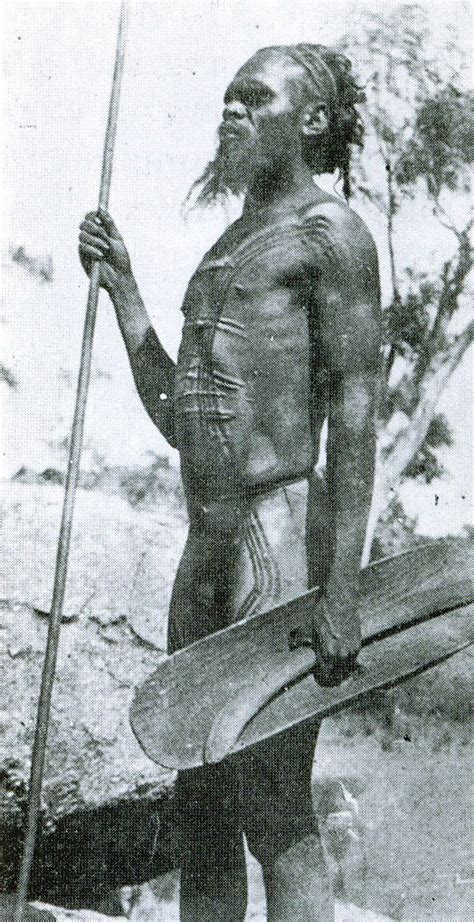 an old black and white photo of a native american man holding a ...