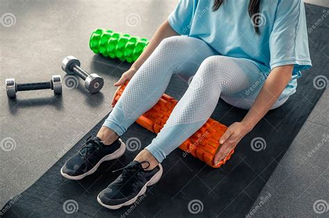 Sport Woman Using Foam Roller for Muscle and Fascia Stretching Foot ...