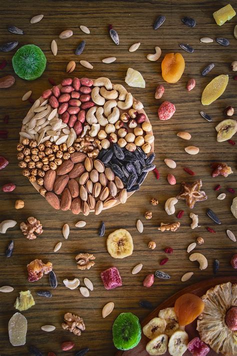 an assortment of nuts and dried fruits on a wooden surface with the word'food art'written below it