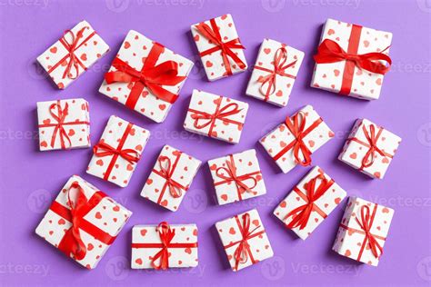 Top view of white gift boxes with hearts on colorful background. Valentine's Day concept ...