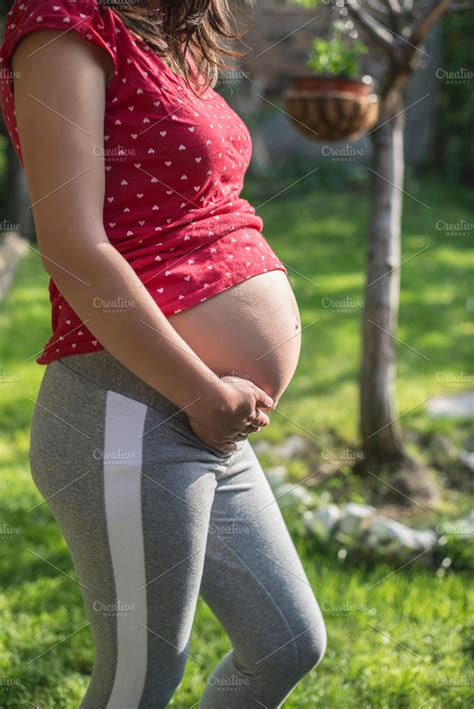 Pregnant woman shows his belly in t containing pregnant, woman, and ...