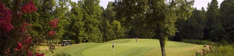 A sunny day view of a green from Rocky River Golf Club at Concord ...