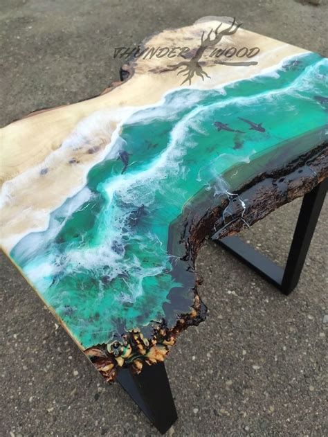 a table that is made out of wood and has an ocean scene painted on it