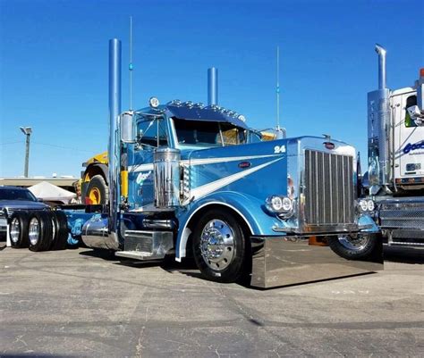 a blue semi truck parked in a parking lot