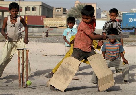 Poor kids playing on the streets of India. (x-post r/cricket) : pics