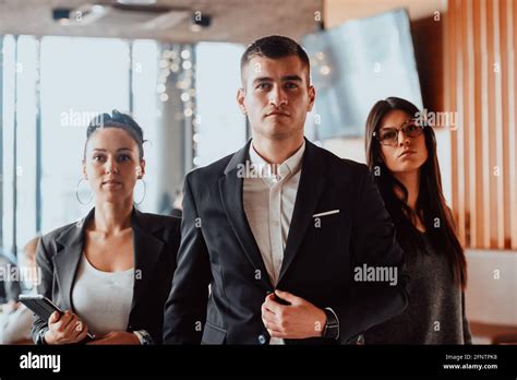 Group of successful business people standing together at office Stock Photo - Alamy