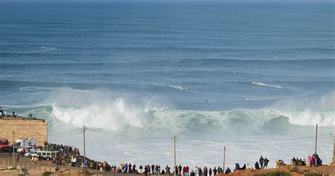 Nazare, Portugal - November 7, 2022 People watching the big giant waves crashing in Nazare ...