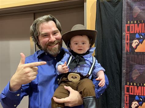 Rodger Clark, voice actor for Arthur Morgan, holding a baby cosplaying as Arthur Morgan. : r/aww