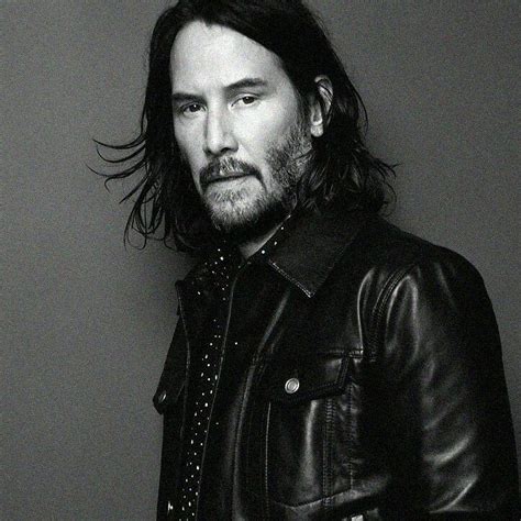 a man with long hair wearing a leather jacket