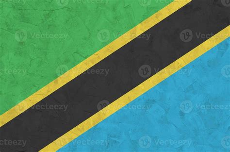 Tanzania flag depicted in bright paint colors on old relief plastering wall. Textured banner on ...