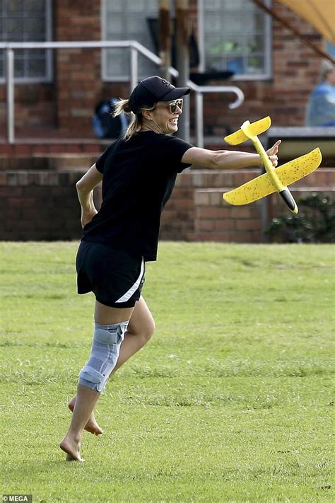 Allison Langdon sports a knee brace while playing with her son Mack ...