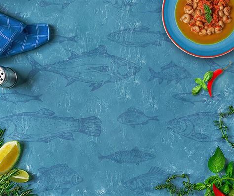 Premium Photo | A blue tablecloth with fish on it and a plate of food ...