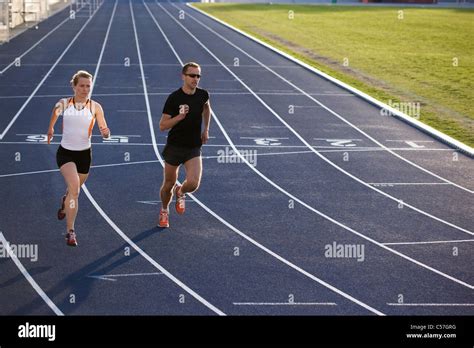 Runners racing on track Stock Photo - Alamy