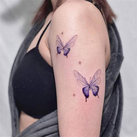 two purple butterflies on the right arm and shoulder, with stars in the back ground