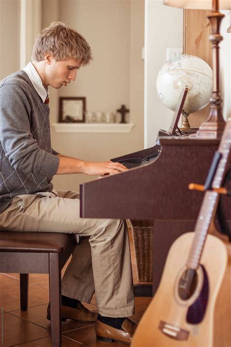 "Teenager Playing Piano At Home" by Stocksy Contributor "Geoffrey Hammond" - Stocksy