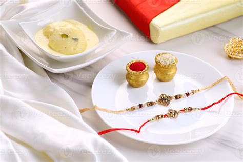 Indian Festival Raksha Bandhan with Rakhi, Sweets, Rice Grains, 3296585 Stock Photo at Vecteezy