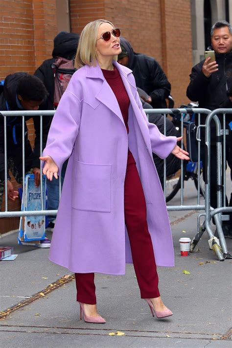 kristen bell poses in a red velvet outfit with lavender coat while out ...