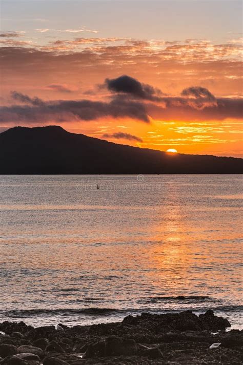 Sunrise Shows Half Sun Over Rangitoto Volcano Near Auckland. Stock ...