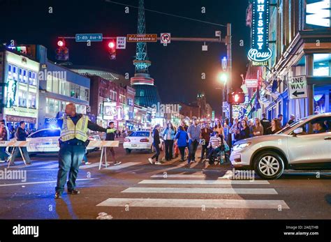 People enjoy Broadway by night in Nashville. This historic street in ...