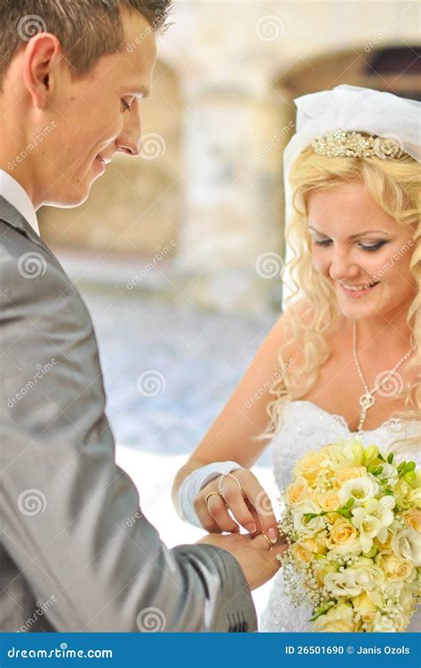 Bride giving ring to groom stock photo. Image of flower - 26501690