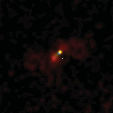 an orange object is seen in the dark with red spots on it's surface