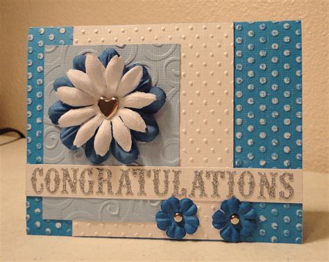 a blue and white card with a flower on the front, congratulations ...