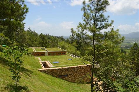 Grass Roofed Home Built into Slope uses Hillside for Cooling