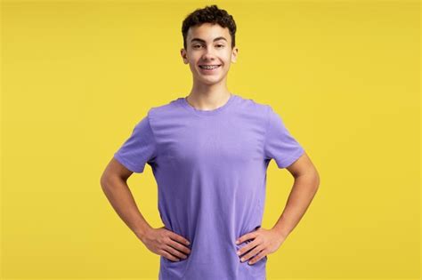 Premium Photo | Portrait of confident smiling boy with dental braces wearing purple t shirt ...