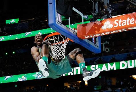 Jeremy Evans hanging onto the hoop after completing a dunk in the 2012 ...