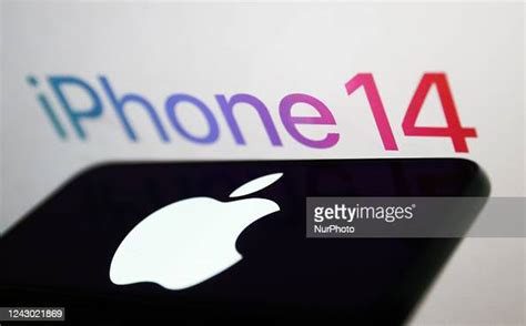 iPhone 14 logo sign displayed on a screen and Apple logo displayed on ...