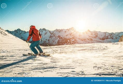 Young Man Skiing in Alps Mountains on Sunny Day - Skier Training during Winter Season at Sunset ...