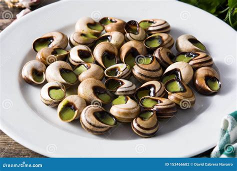 Escargots De Bourgogne on Wooden Table Stock Photo - Image of copyspace, cooked: 153466682