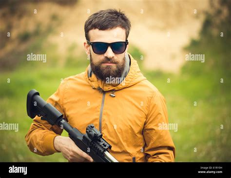 A man with an automatic rifle outdoor Stock Photo - Alamy