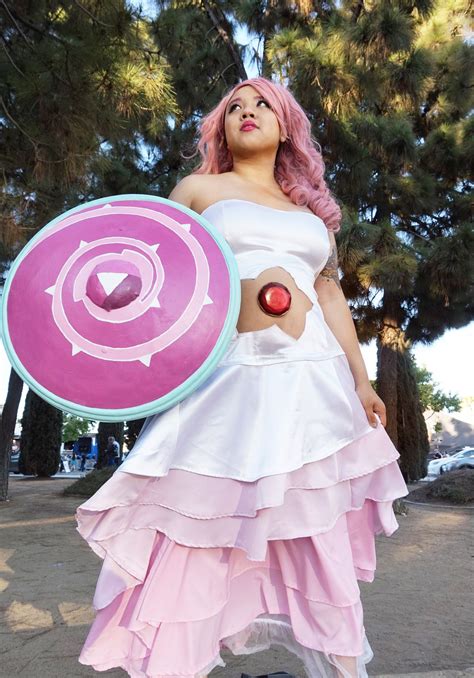 a woman with pink hair is holding a frisbee