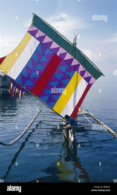 Sulu Sea Muslim vinta outrigger boat Colourful sail Two men ZAMBOANGA MINDANAO PHILIPPINES Stock ...