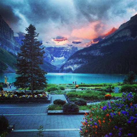 Brilliant sunrise over Lake Louise, Banff. Fairmont Chateau Lake Louise ...