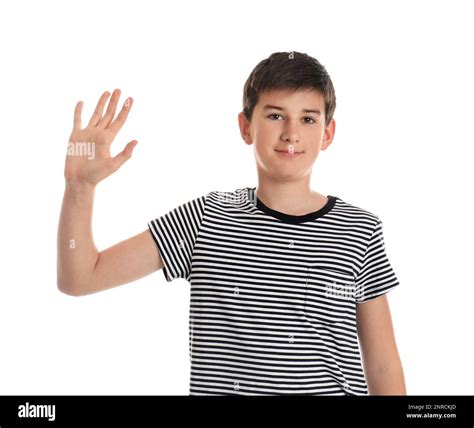 Happy teenage boy waving to say hello on white background Stock Photo ...