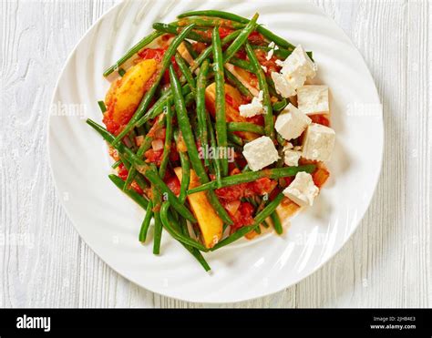 fasolakia lathera, green beans, onion and potatoes stewed in tomato, herbs and olive oil on ...